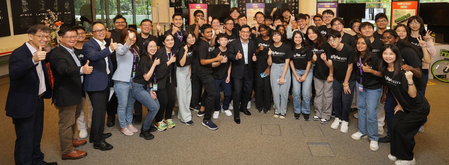 Large group of people giving thumbs-up, many wearing "STEAM Unity" T-shirts.